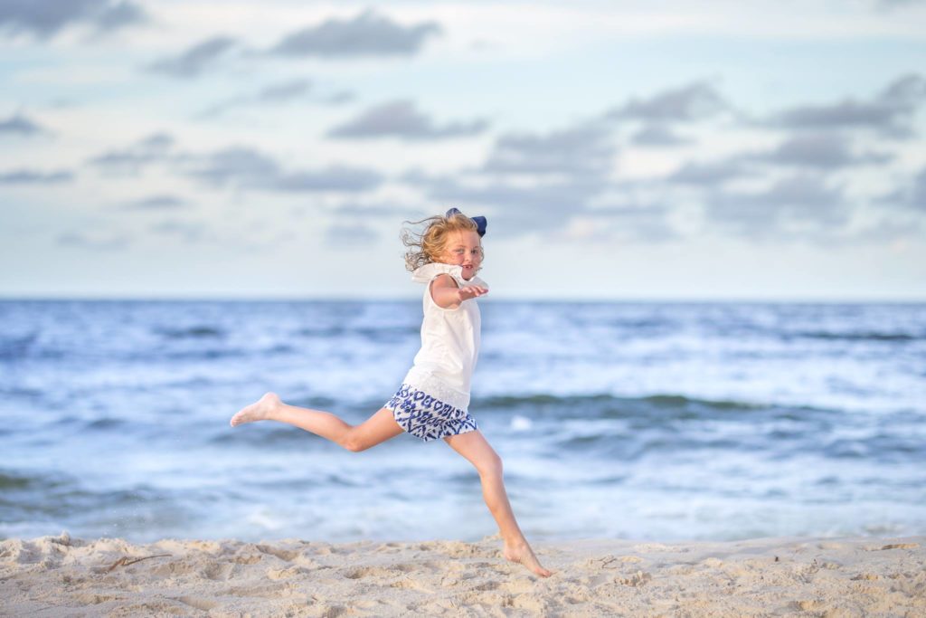 Girl Jumping for joy during her phots in Gulf Shores Al