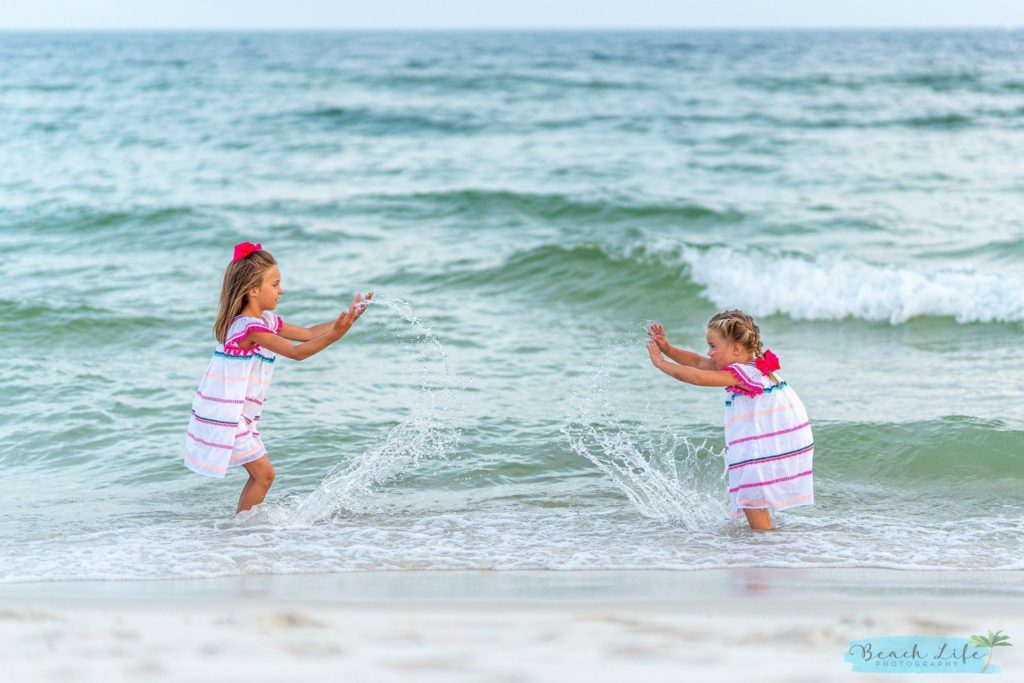 Girls Splashing in the water in Gulf Shores Al photogrphers